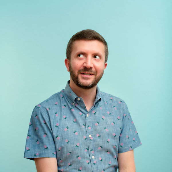 A photo of me wearing a blue shirt in front of a blue background